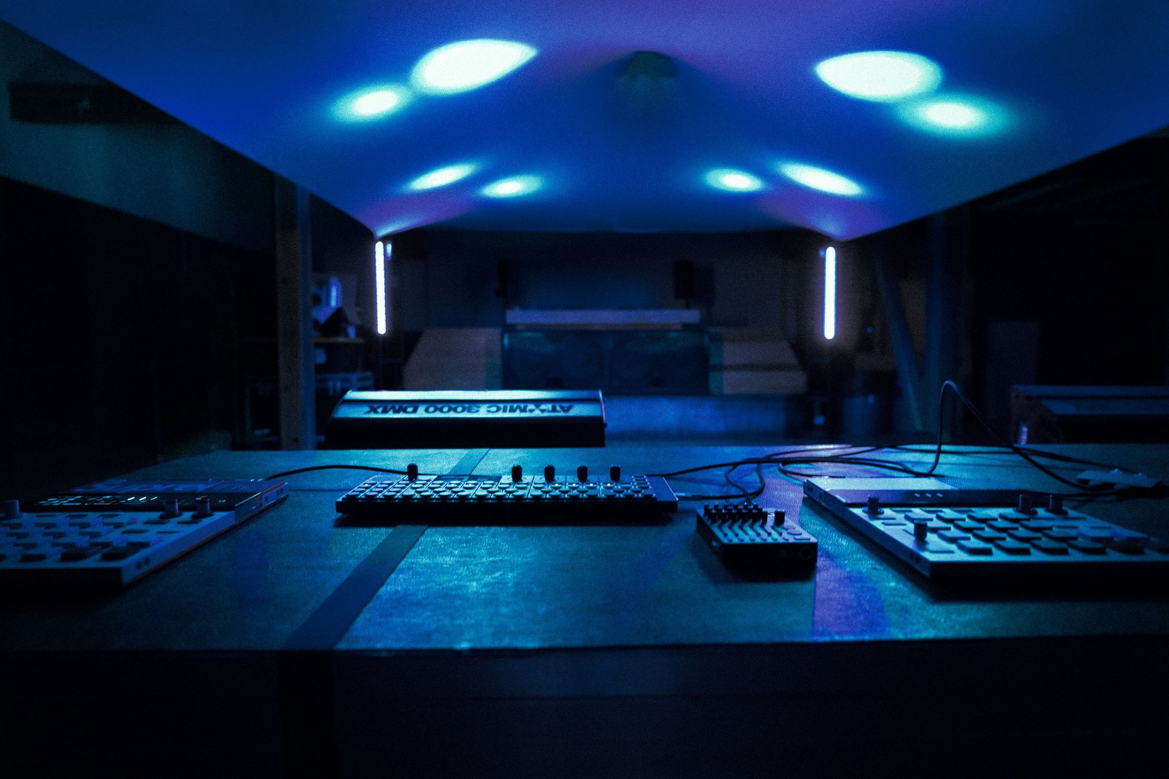 The Teenage Engineering units laid out across the lighting table, the canopy lit blue-green above